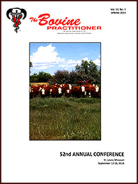 Cover image of Volume 53, No. 1 of the Bovine Practitioner: a photo of a herd of Hereford standing on the edge of an overgrown field, facing towards the camera.