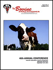 Cover image of Volume 47, No.2 of the Bovine Practitioner: a photo of a Red and White Holstein centered in the frame, bending down slightly to sniff at the photographer. In the background you can see a few other cows and the edge of a forest.