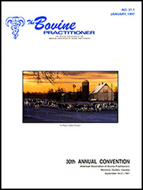 Cover image of Volume 31.1 of the Bovine Practitioner: a reproduction of the painting "A Place Called Home" by Bonnie Mohr, which is of a herd of cows grazing on a purple meadow at sunset. The sillouhette of a metal-sided barn, grain silo, and windmill stand out against the forest.