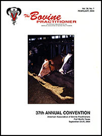 Cover image of Volume 38, No.1 of the Bovine Practitioner: a trio of Ayrshire cattle stick their heads through metal slats to graze on hay
