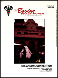 Cover image of Volume 38, No.2 of the Bovine Practitioner: a photo of the Fort Worth Livestock Exchange, with several tents set up in front, a stack of firewood, and a fire pit. Two men wearing cowboy hats and button downs stand in front of the building chatting.