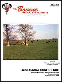 Cover image of Volume 43, No.2 of the Bovine Practitioner: a photo of cattle grazing on a green field at midmorning. There are two trees without leaves and a small group of the cows stand between them, looking at the photographer.
