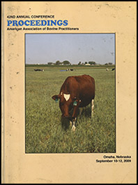 Cover image of the 42nd Conference Proceedings: Cattle grazing in a spring field along the horizon. In the foreground, one brown cow with a triangle marking and ear tags is posing. Yellow background.