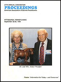 Cover image of the 27th Conference Proceedings: A photo of Dr. and Mrs. Elmer Woelffer. Mrs. Woelffer is holding a statue of a bull. White background.