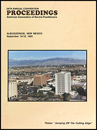 Cover image of the 26th Conference Proceedings: A photo of the Albuquerque skyline during midday. In the foreground are skyscrapers, the scene is dotted with trees and scrub land, and a mountain rises behind the city. Yellow background.
